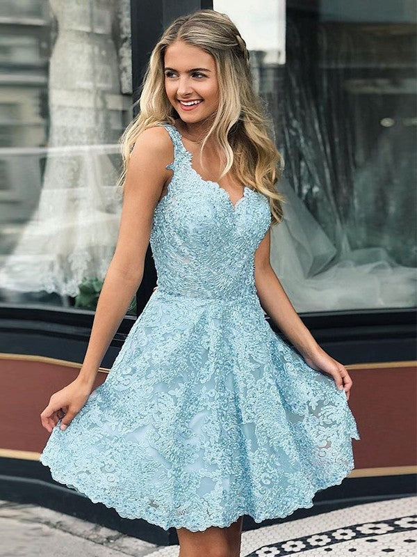 Model wearing an elegant white A-line lace mini dress with a V-neck, perfect for homecoming.