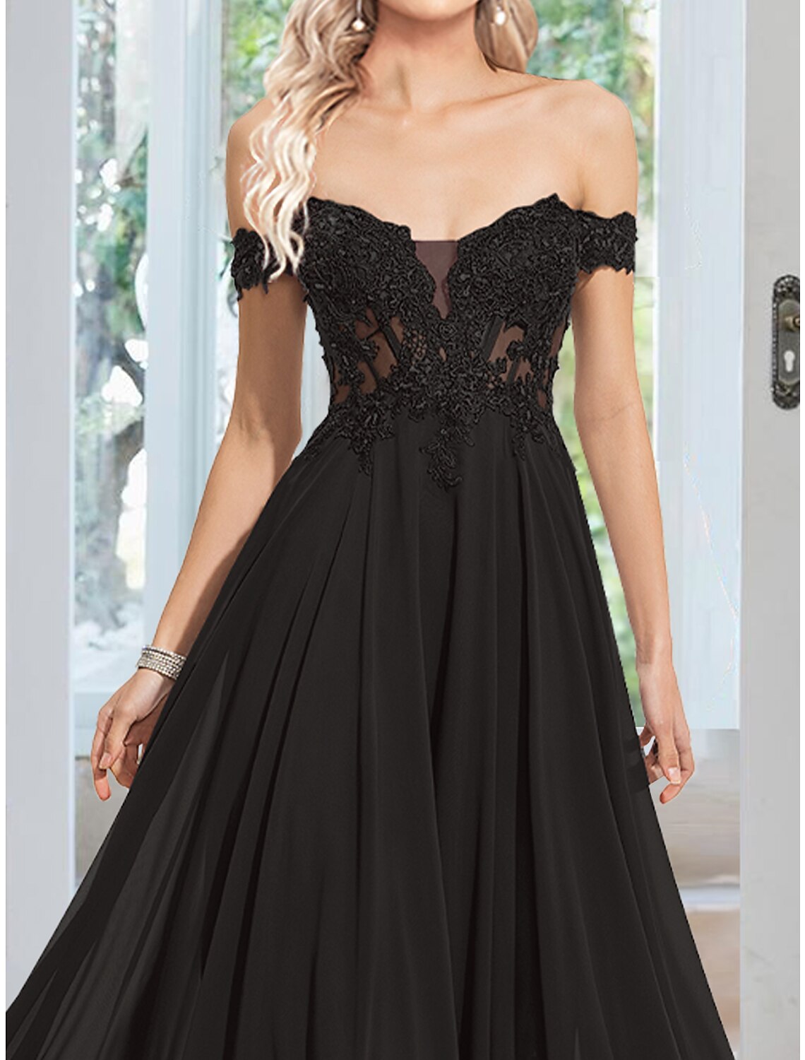 Close-up of the floral appliques on the chiffon evening dress.