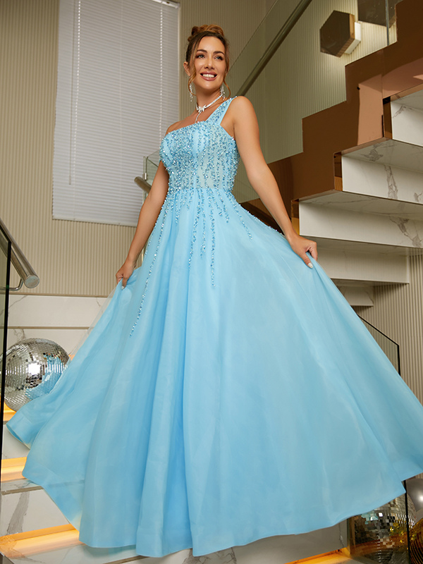 Model wearing an elegant aqua blue A-Line Princess evening gown with intricate beading.