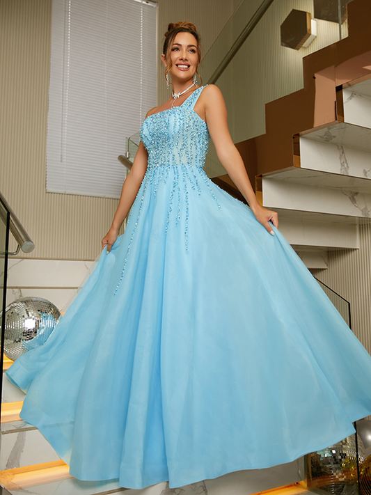 Model wearing an elegant aqua blue A-Line Princess evening gown with intricate beading.