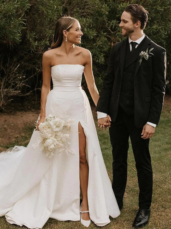 Elegant A-Line Princess wedding gown with strapless ruched bodice and cathedral train.