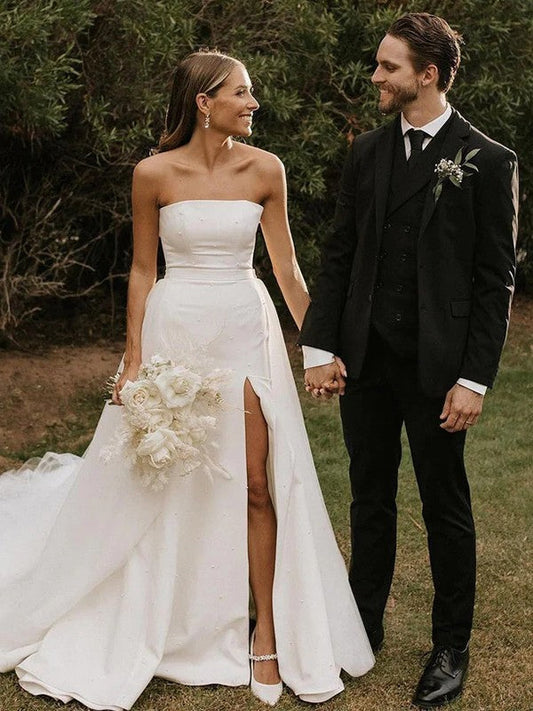 Elegant A-Line Princess wedding gown with strapless ruched bodice and cathedral train.