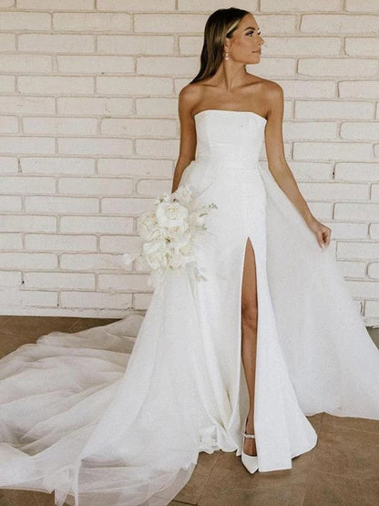 Side view of strapless A-Line Princess wedding dress showing ruched details and long cathedral train.