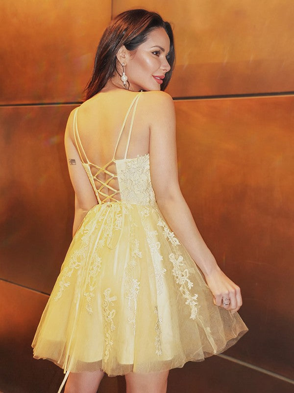 Side view of aqua blue tulle mini dress with spaghetti straps.
