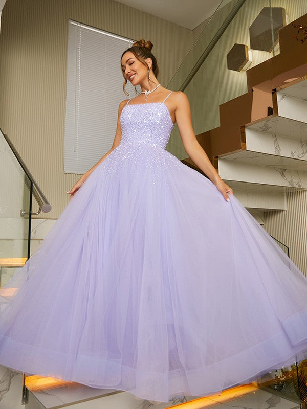 Back view of the floor-length A-line princess gown, showcasing tulle and beading.
