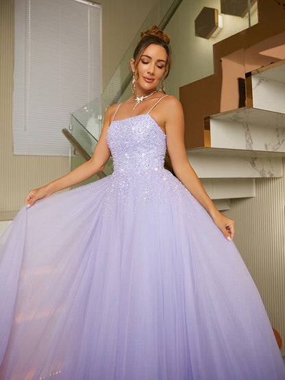 Detailed view of the flowing tulle skirt and floor-length design of the evening gown.