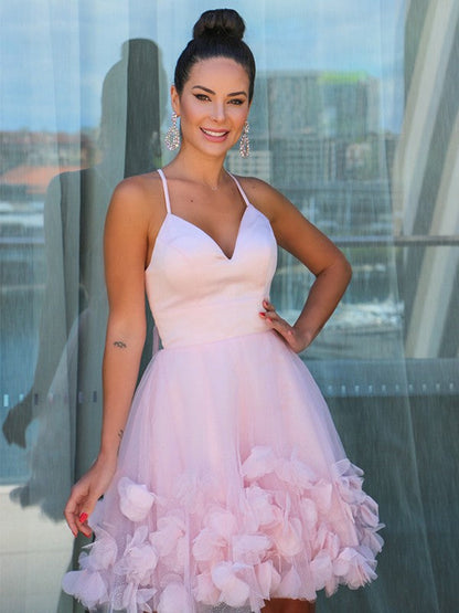 Detail shot of the satin fabric and delicate spaghetti strap on the homecoming dress.