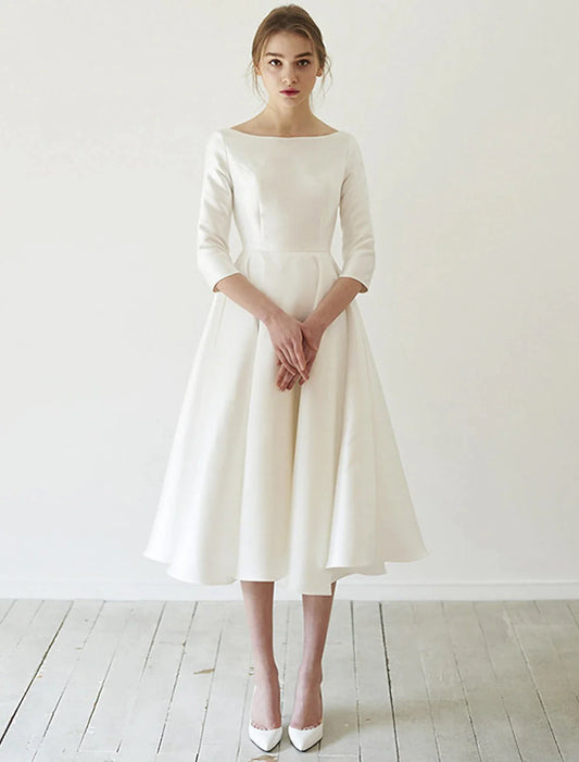 Elegant A-line tea length satin reception wedding dress with 3/4 sleeves and pleats.