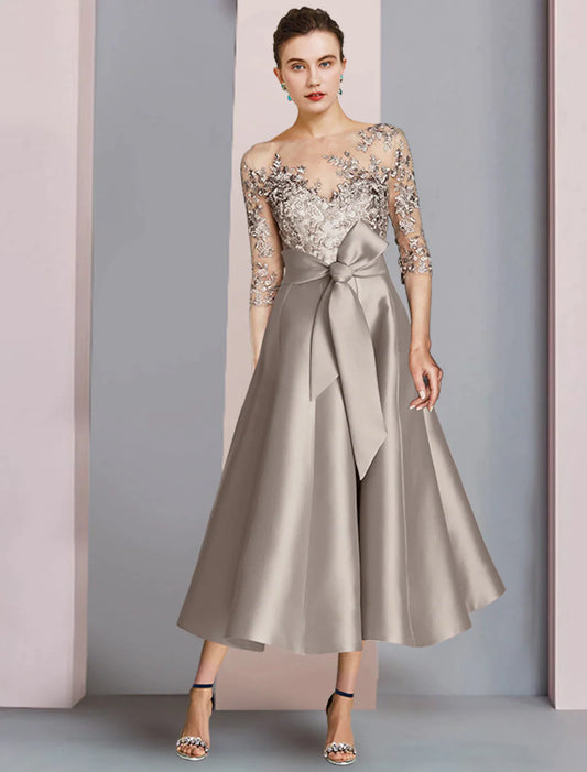 Elegant A-line tea-length Mother of the Bride dress with scoop neck and half sleeves.