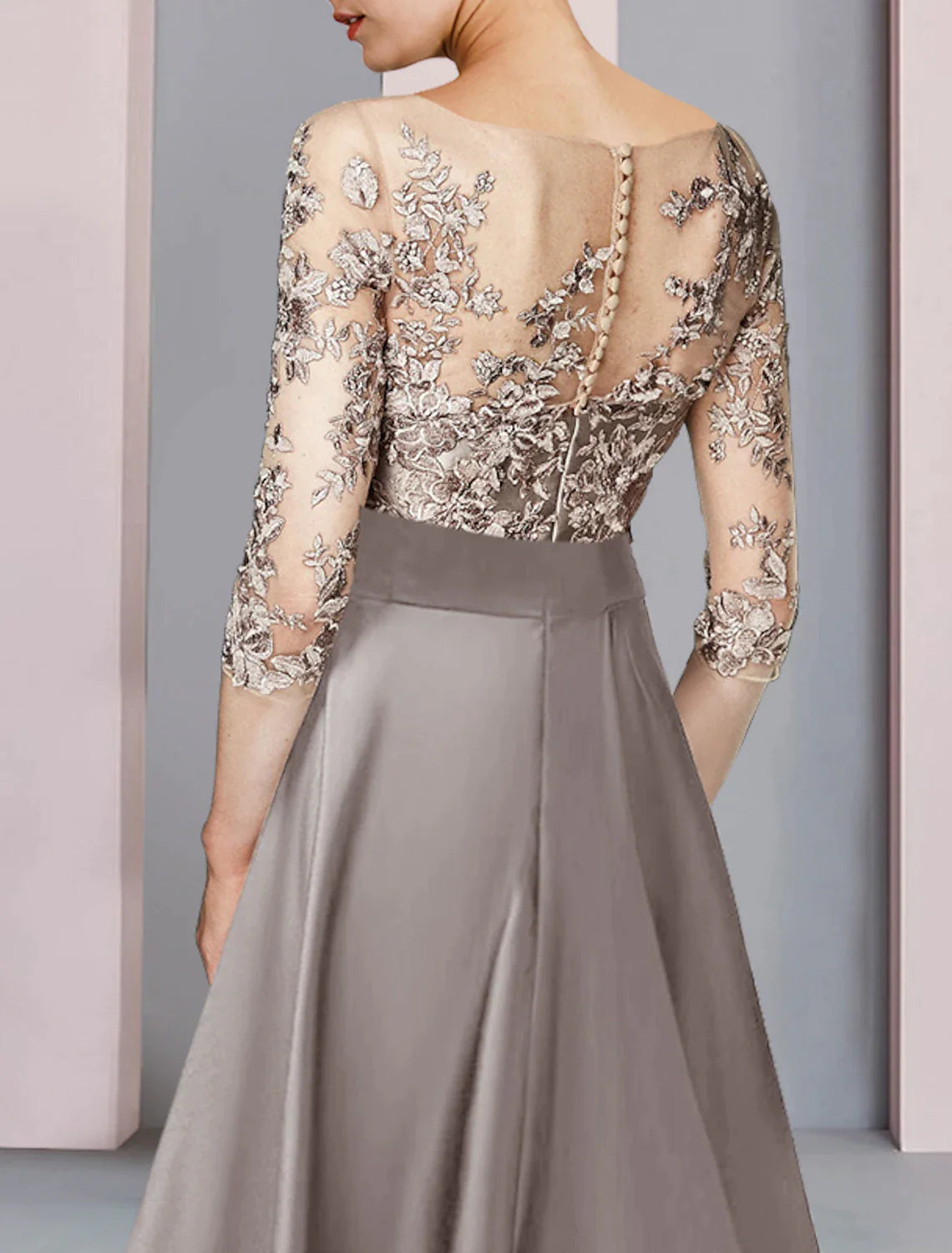 Close-up of the intricate lace and applique details on the half-sleeve A-line dress.