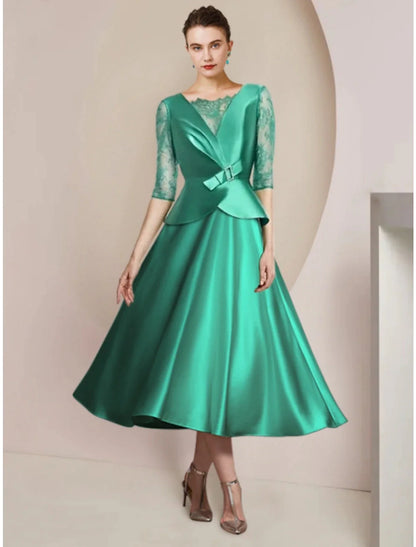 Elegant A-line tea-length dress with scoop neck, half sleeves, and bow detail, front view.