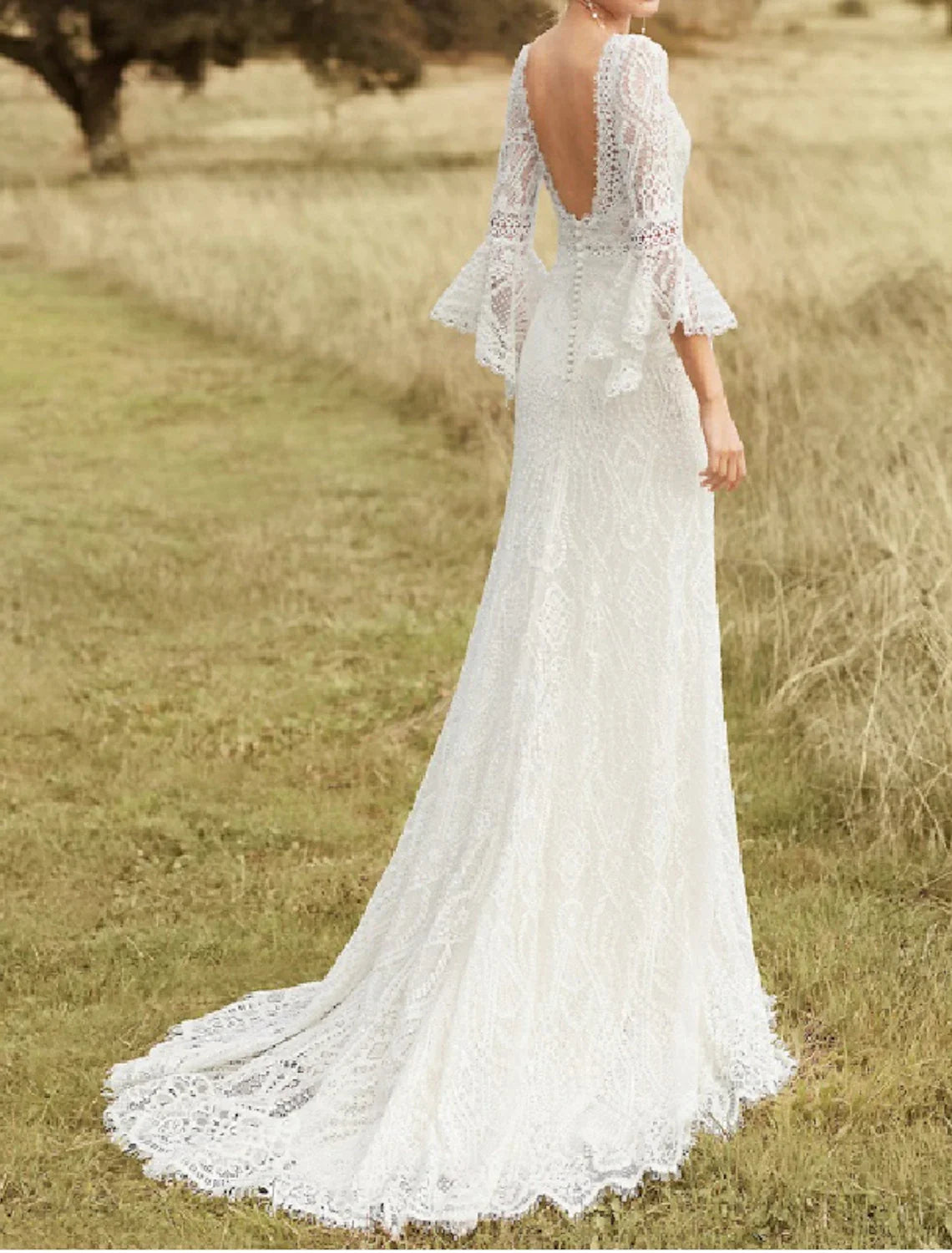 Full length view of the boho lace wedding dress with a sweep train.