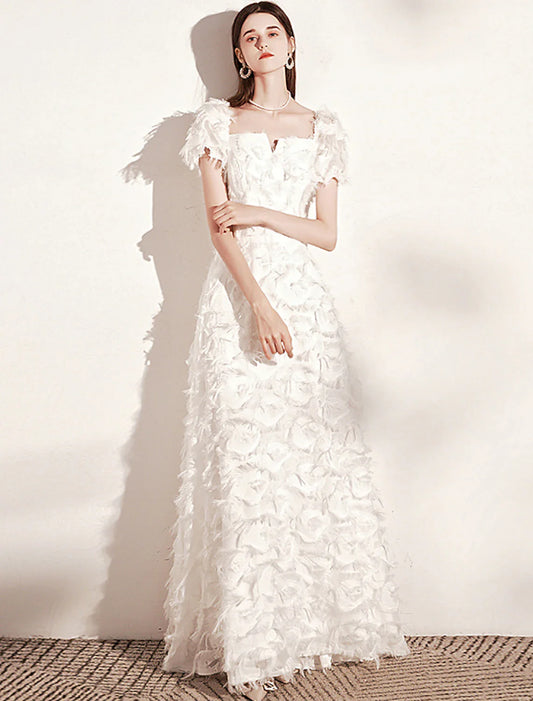 Model wearing an elegant A-line scoop neck short sleeve gown with feather detail.