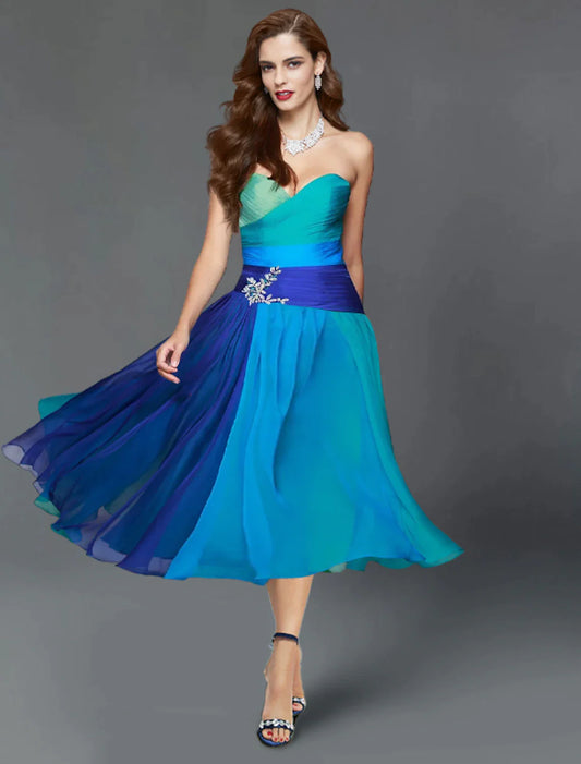 Woman wearing an elegant A-line color block tea length dress with short sleeves and ruched details, perfect for a wedding.
