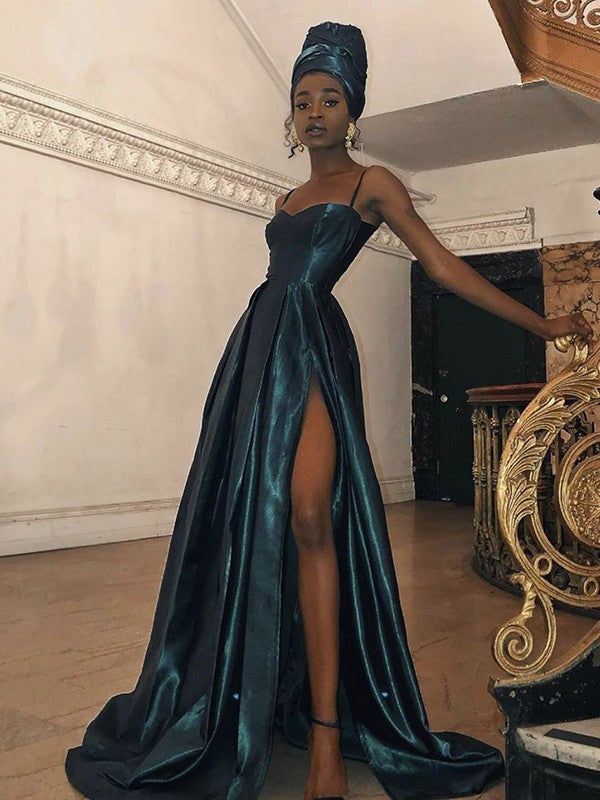 Woman wearing an elegant A-line silk-like satin gown with spaghetti straps, ruffles, and a sweep train.