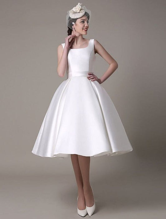 Model wearing an elegant A-line satin cocktail dress with a square neck and pleats, knee-length.