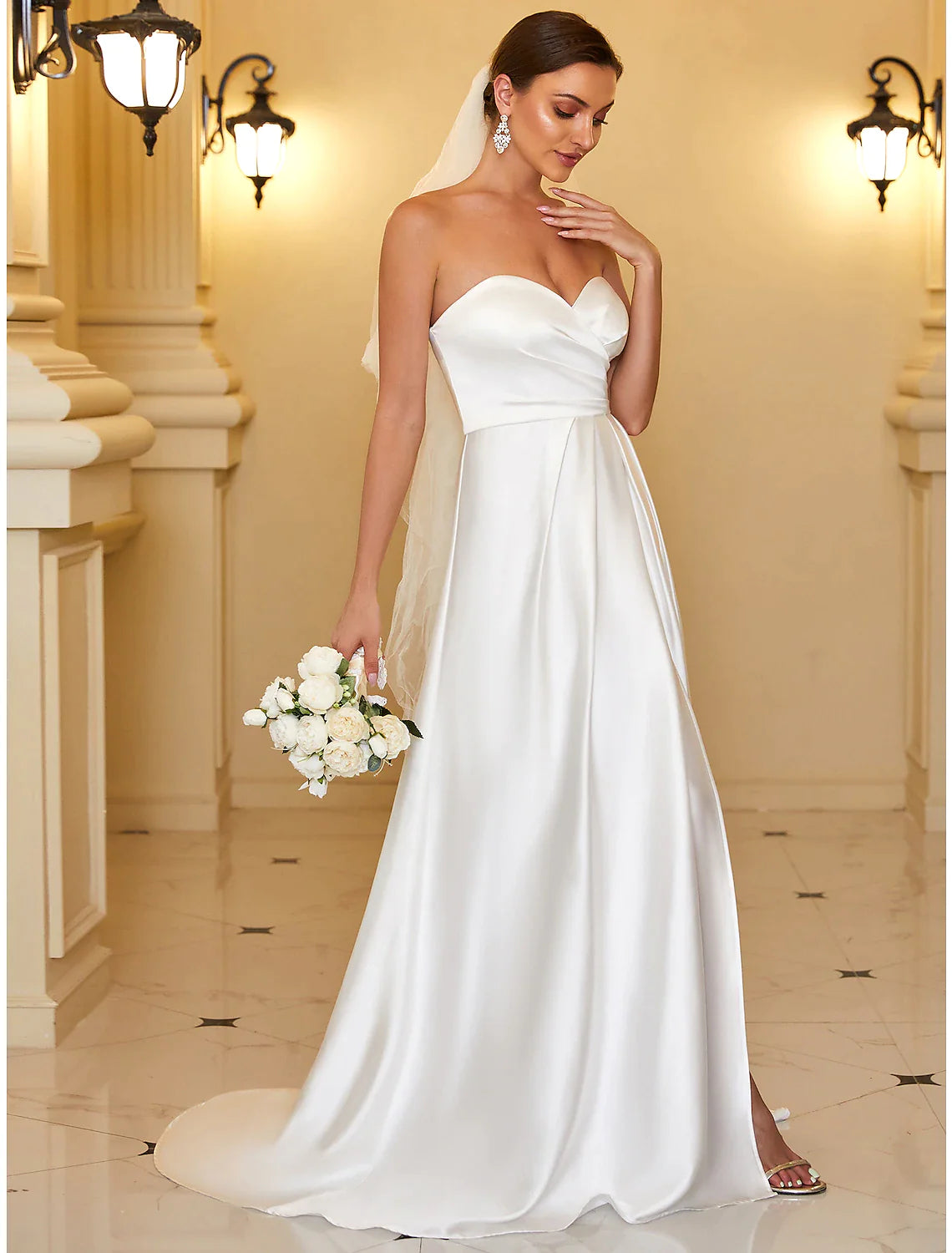 Close-up of the luxurious satin fabric and strapless neckline of the A-line gown.