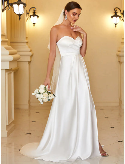 Close-up of the luxurious satin fabric and strapless neckline of the A-line gown.