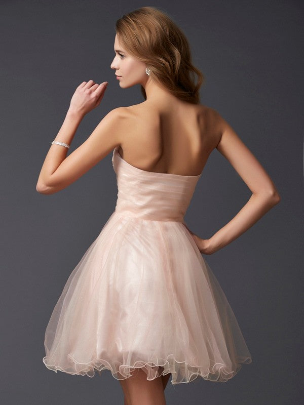 Back view of a sleeveless silk-like satin homecoming dress.