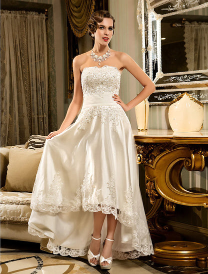 Side view of the strapless A-line white wedding dress, highlighting lace details.