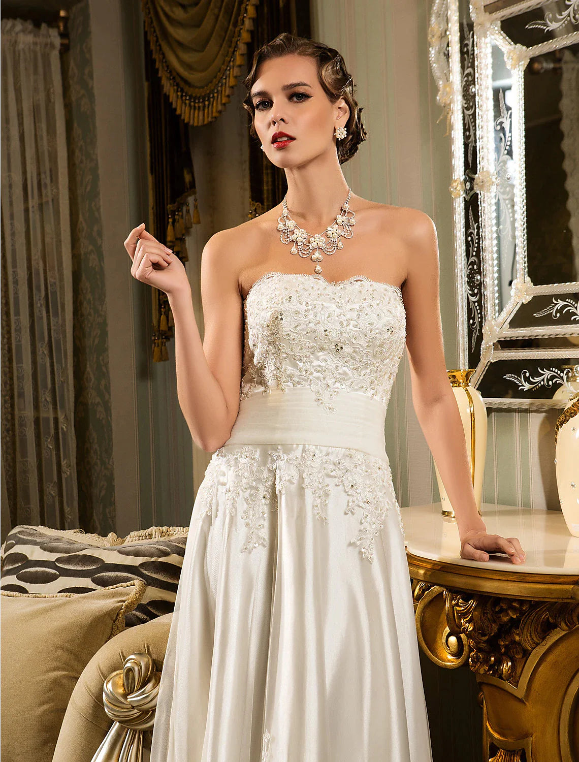 Close-up of the sweetheart neckline and intricate lace appliques on the white wedding dress.