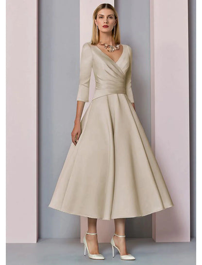 Model wearing an elegant A-line V-neck 3/4 sleeve tea-length satin dress with pleats.