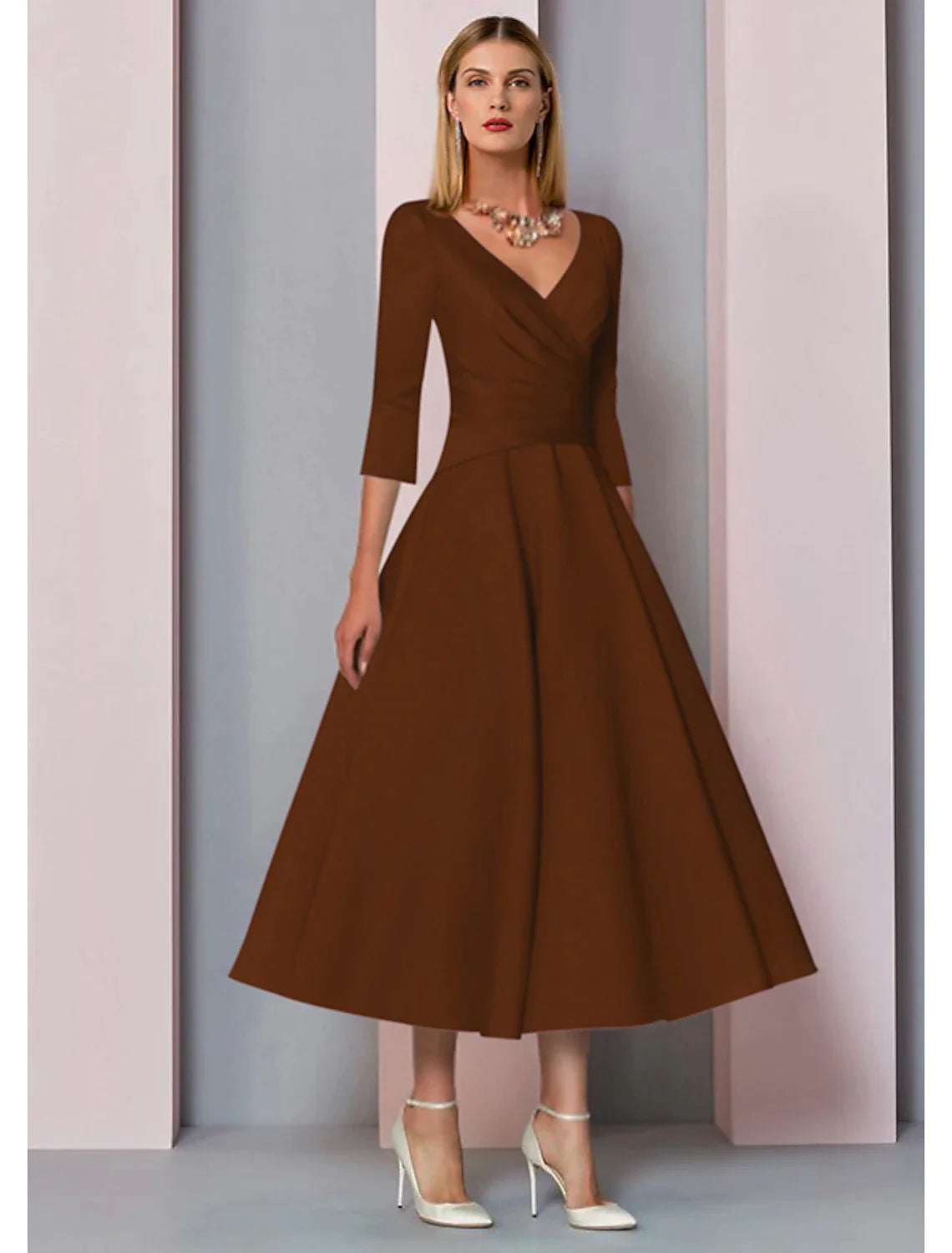 Back view of a model in an A-line V-neck 3/4 sleeve satin dress, showing pleats.
