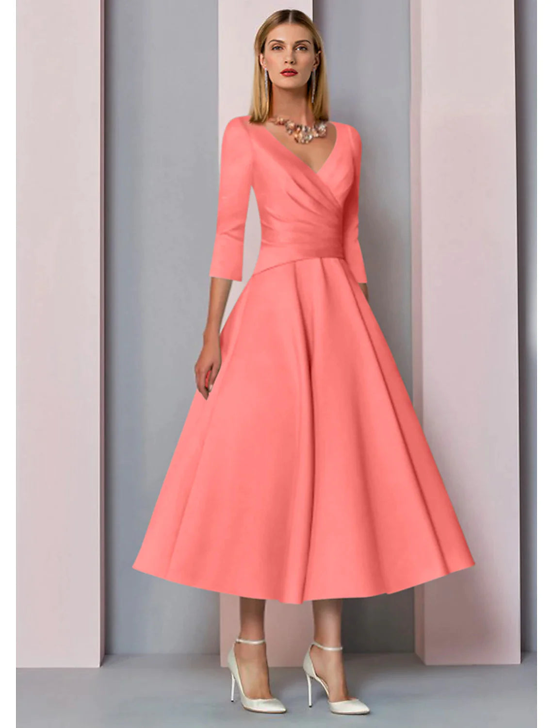 Close-up of the V-neckline and 3/4 sleeves on the elegant satin dress.