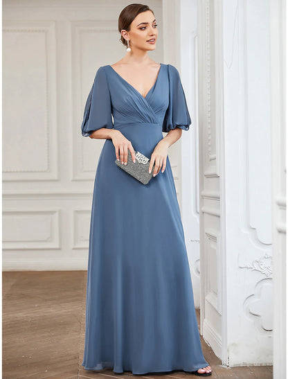 Back view of a light blue A-line V-neck gown with flowing chiffon.