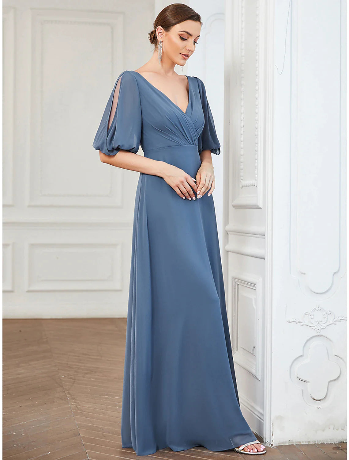 Close-up of the pleated bodice and half sleeves of a light blue chiffon gown.