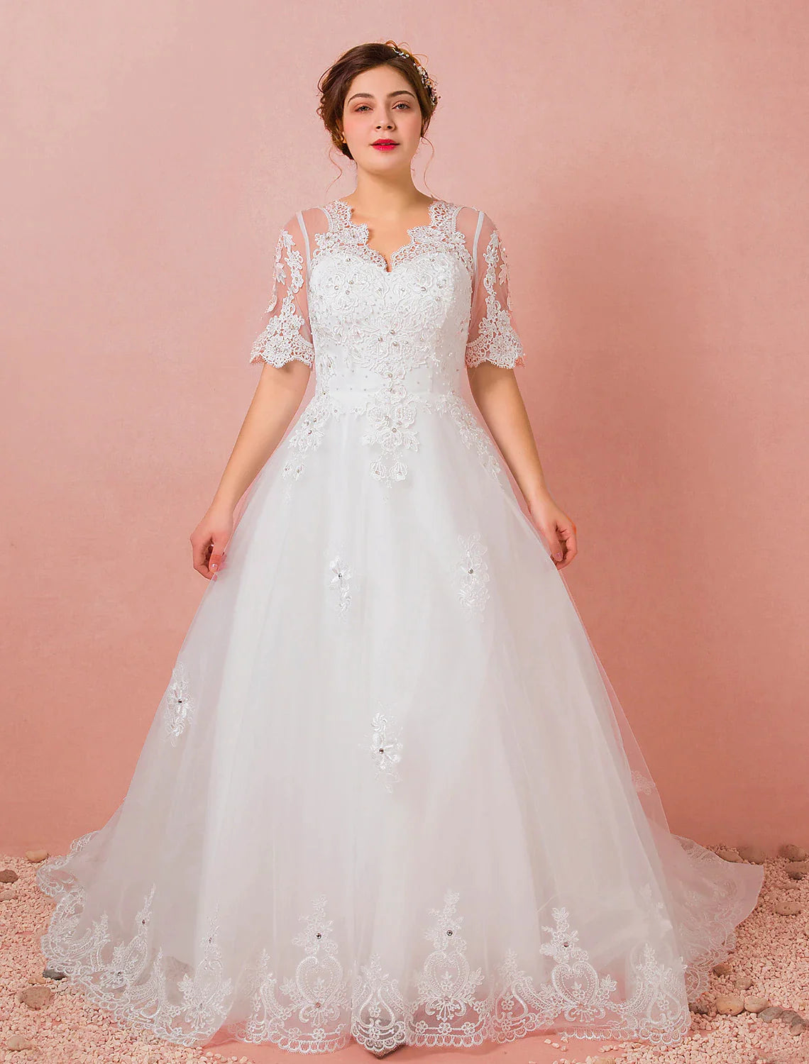 Model wearing an elegant A-Line V-neck half sleeve satin wedding dress with a cathedral train.