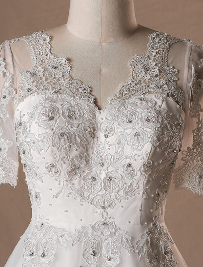 Detailed view of the intricate lace and crystal embellishments on the wedding dress.