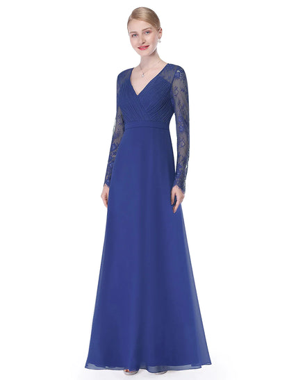 Woman wearing an elegant A-Line V-neck long sleeve chiffon gown.