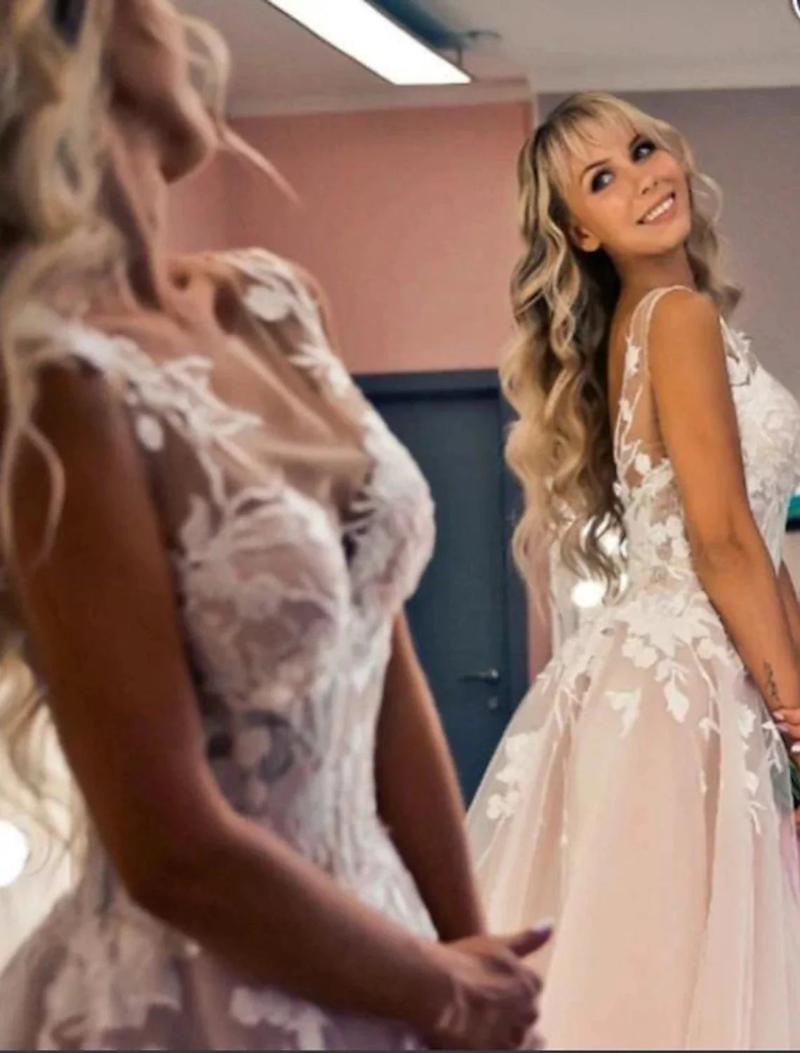 A-line V-neck wedding dress with an open back and lace appliques.