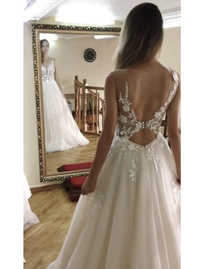 Close-up of the V-neckline and intricate lace appliques on the bridal gown.