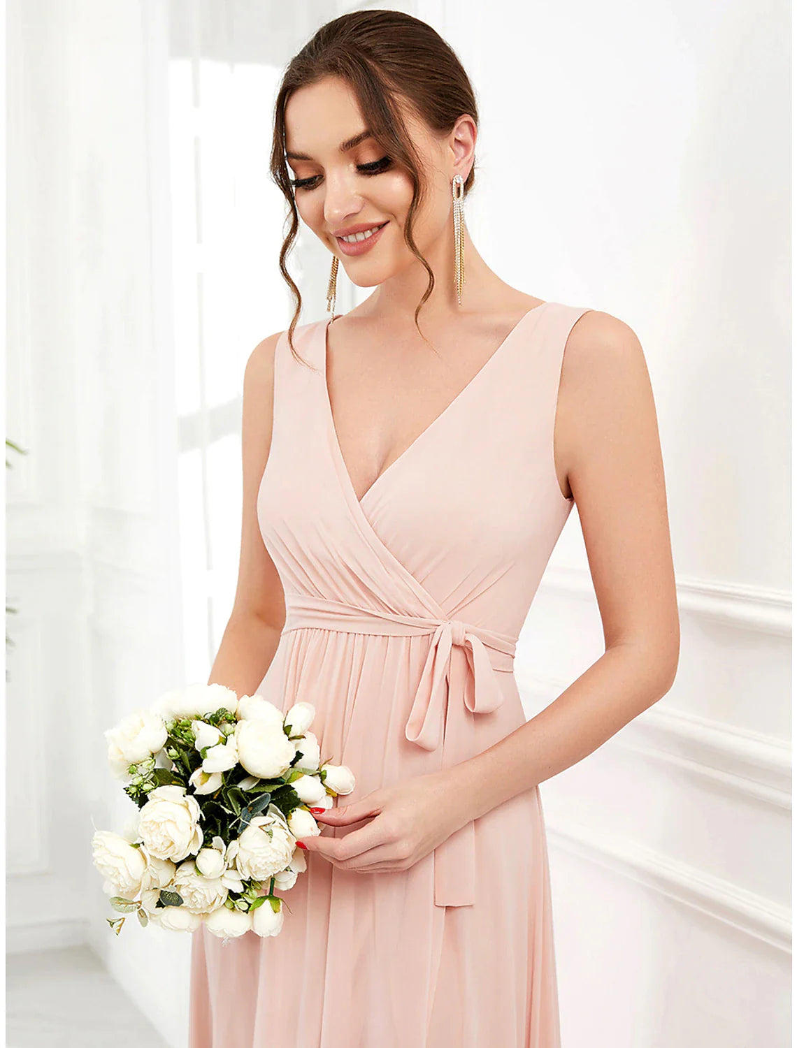 Side view of a woman in an A-line V-neck ruffled chiffon dress, showing asymmetrical hem.