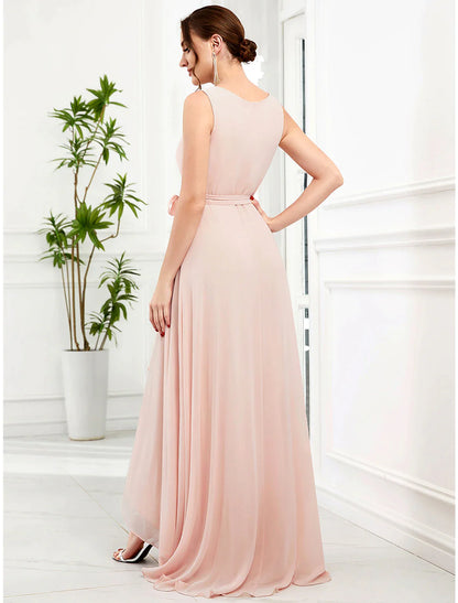 Back view of a woman in an A-line V-neck ruffled chiffon dress, highlighting strappy details.