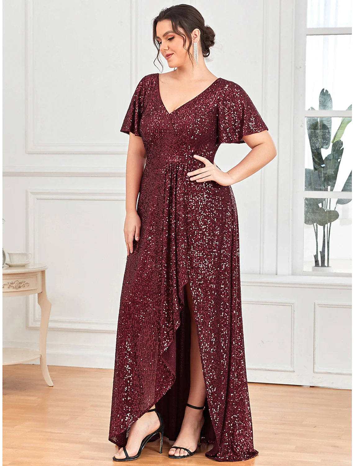 Close-up of the shimmering sequin detail and V-neckline on the A-line evening gown.