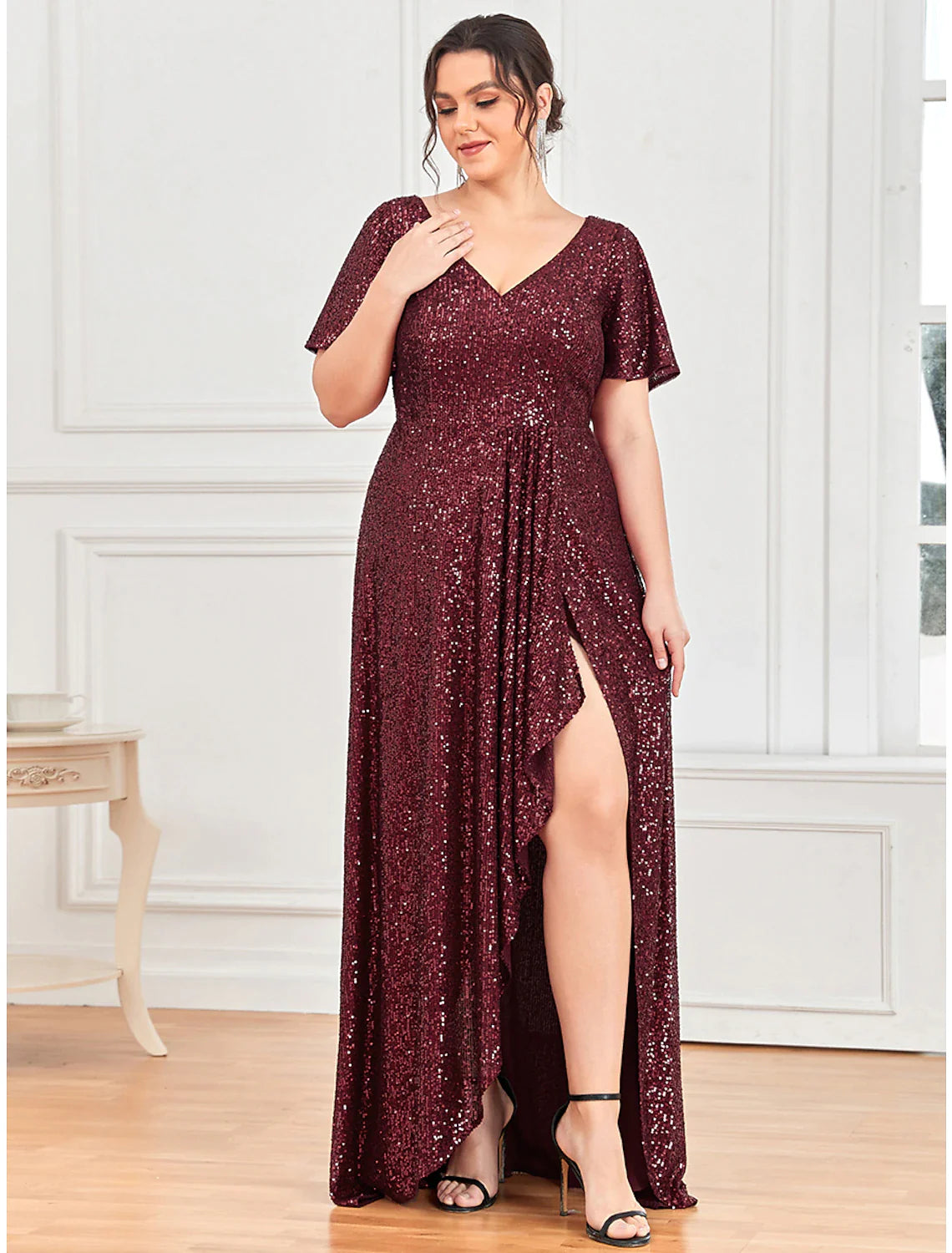 Back view of the A-line sequined evening gown, showcasing its floor-length silhouette.