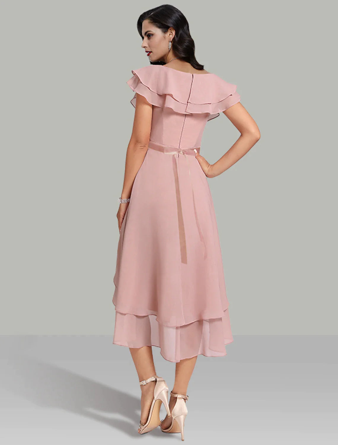 Side view of a flowing chiffon A-Line dress with tiered skirt.