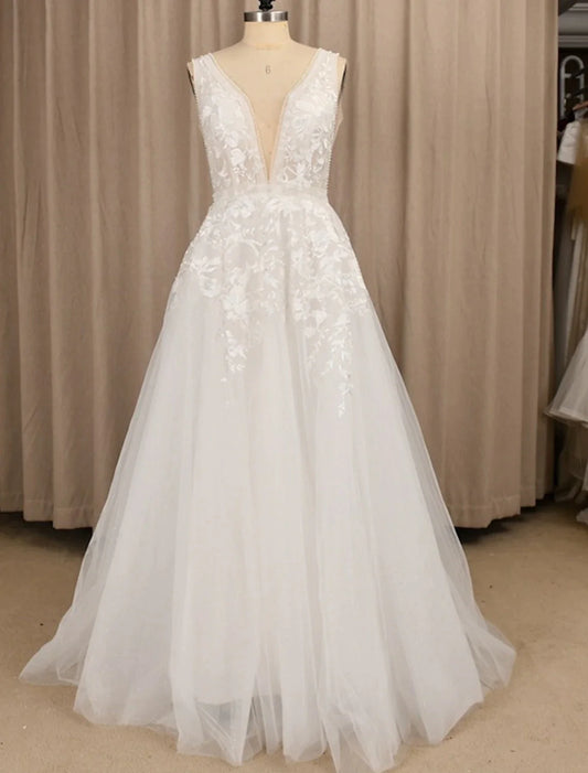 Elegant A-Line V-Neck sleeveless lace beach wedding dress with appliques.