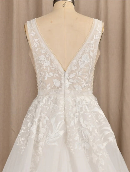 Close-up of delicate lace and floral appliques on the bridal gown.