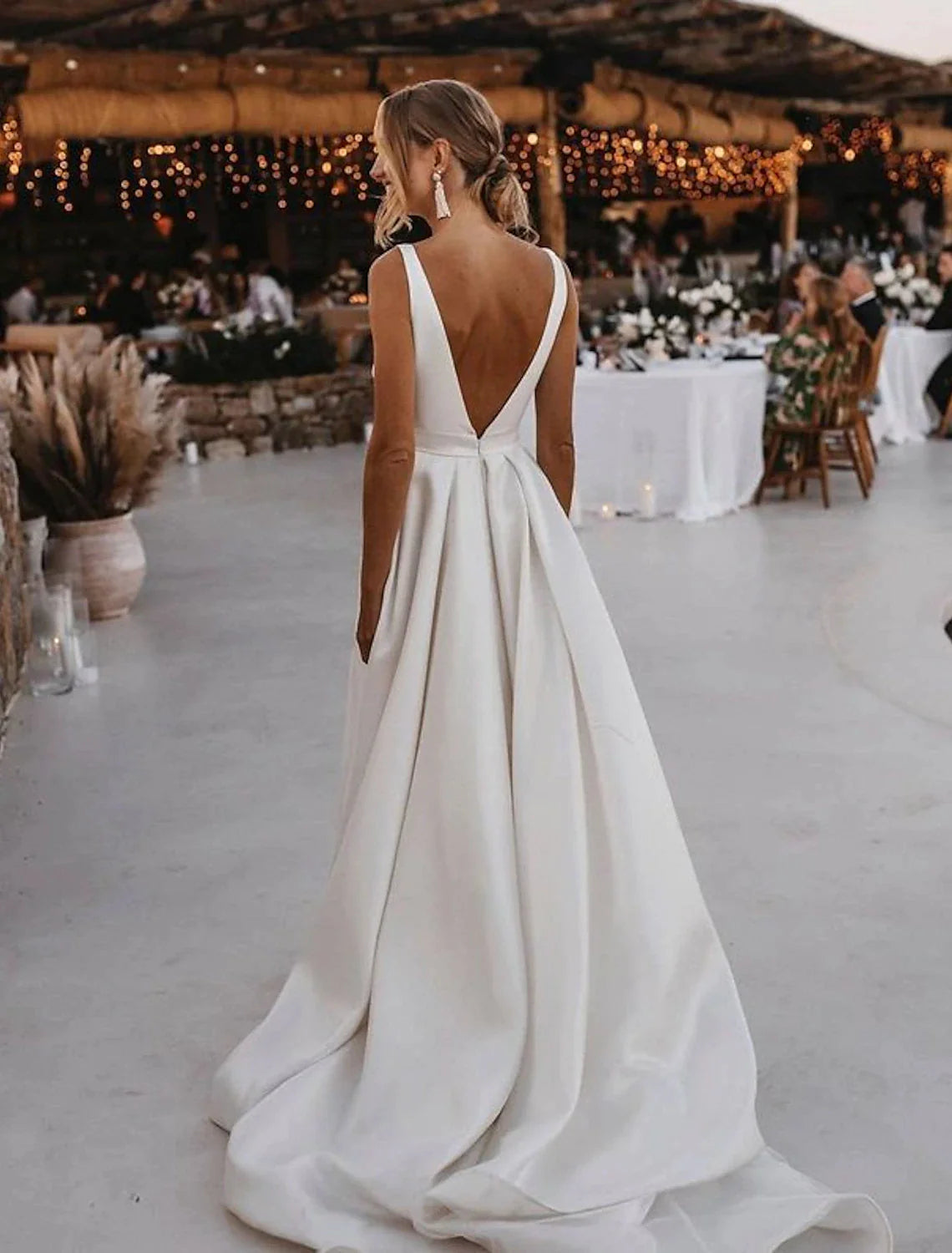 Back view of A-line satin wedding dress with court train and sashes.