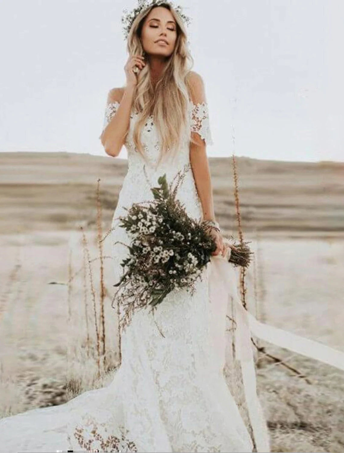 Back view of the mermaid wedding dress showing chapel train and lace details.