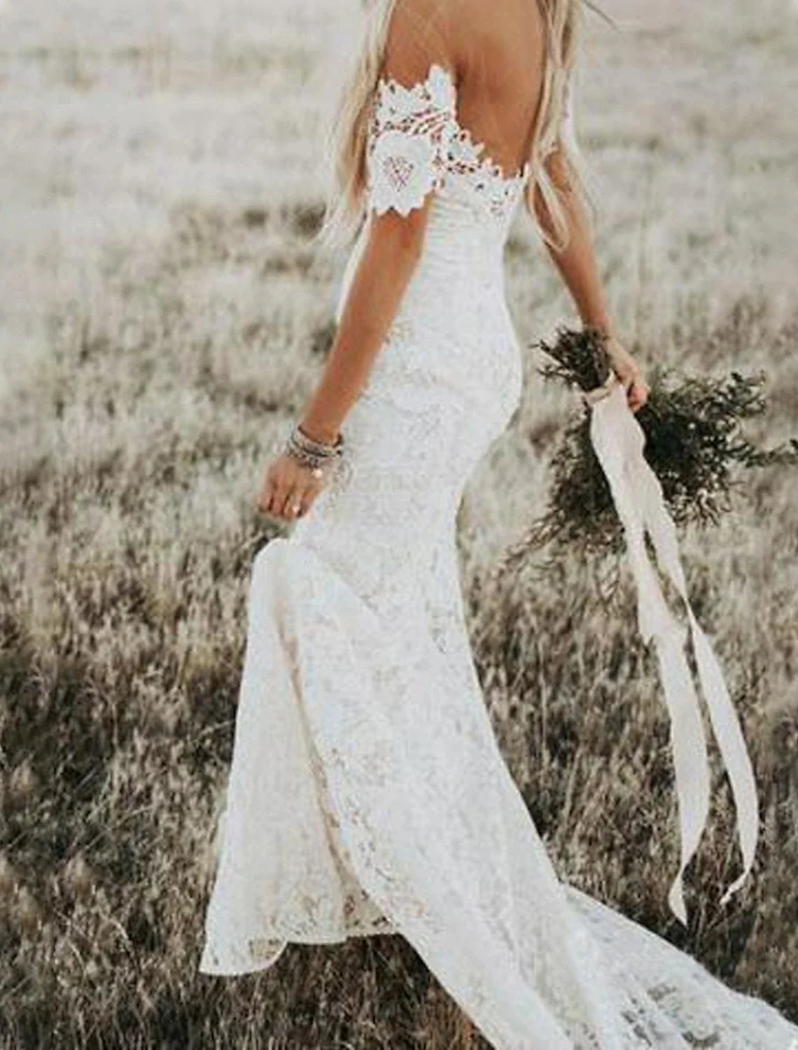 Detail of the lace appliques and fabric texture on the wedding dress.