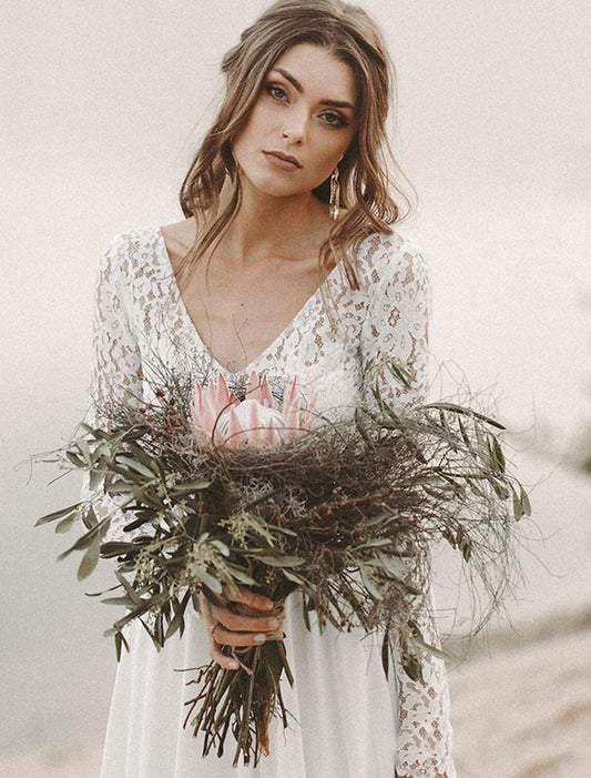 Model wearing an elegant A-line V-neck long-sleeve chiffon wedding dress with a sweep train outdoors.