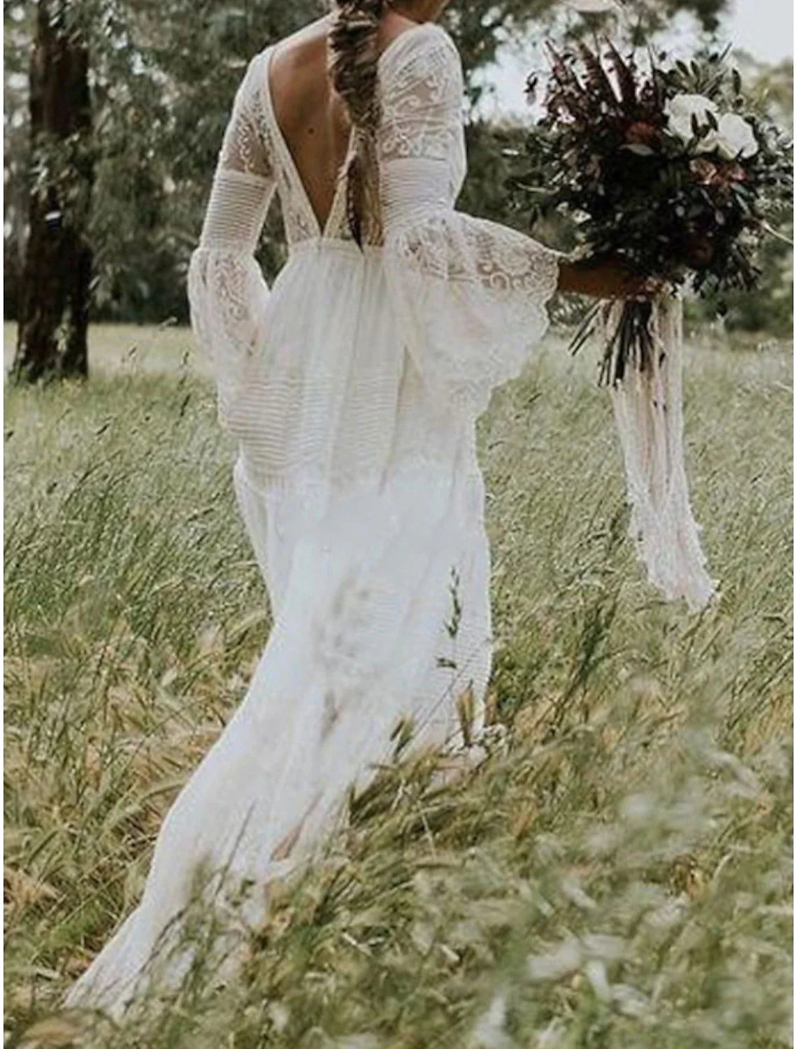 Close-up of the V-neckline and delicate lace details on the long sleeve wedding dress.