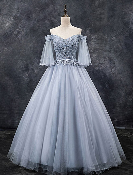 Model wearing an elegant blush pink off-shoulder ball gown with floral appliques and half sleeves.