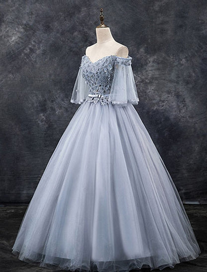 Back view of the elegant blush pink off-shoulder ball gown with floral appliques.