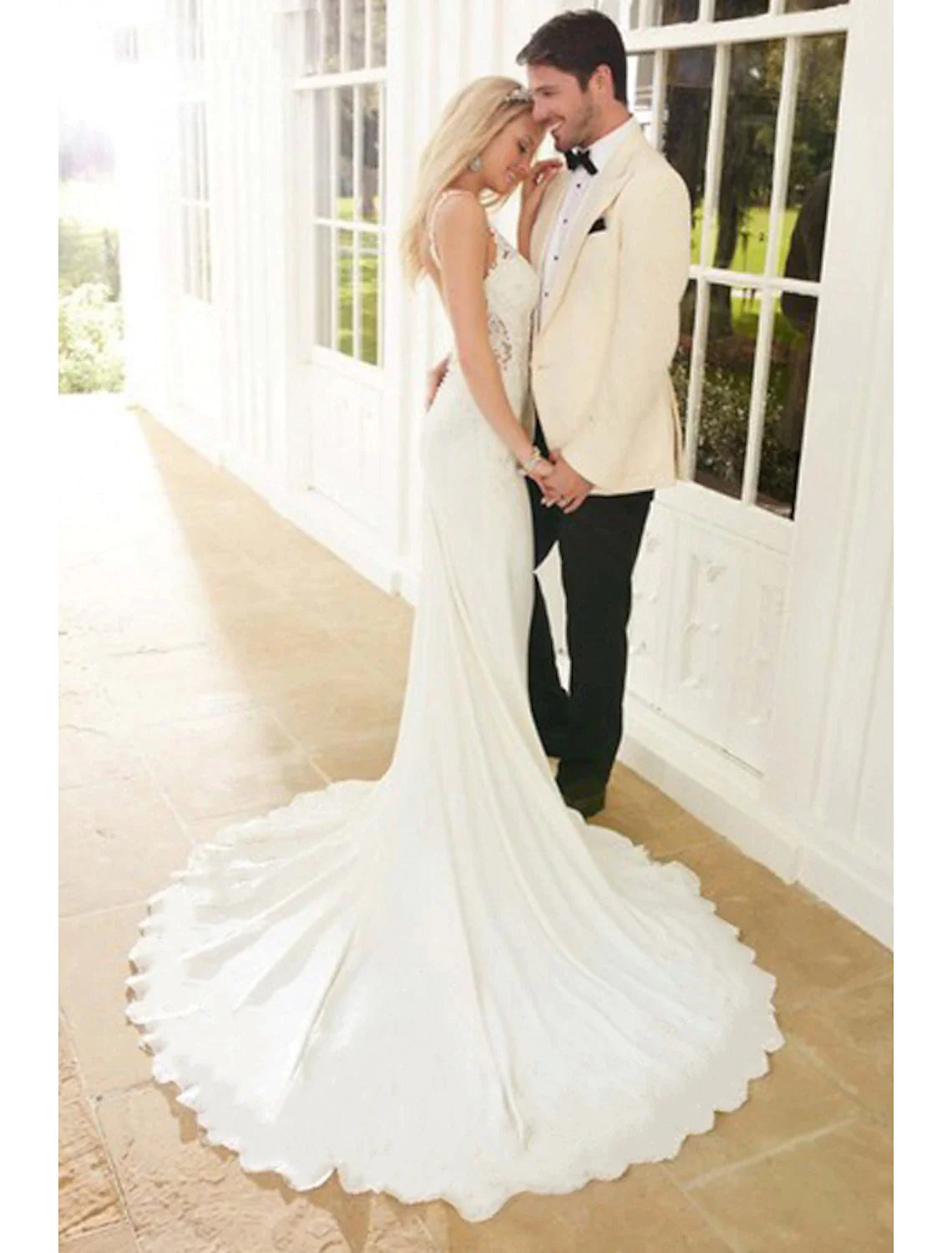 Elegant mermaid V-neck wedding dress with lace appliques.